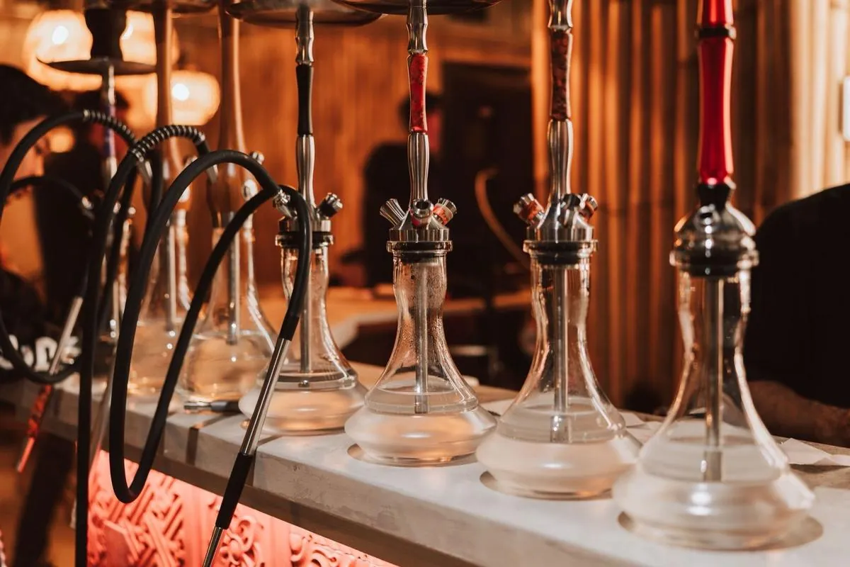 A row of glass-base shisha pipes lined up at Komodo Lounge