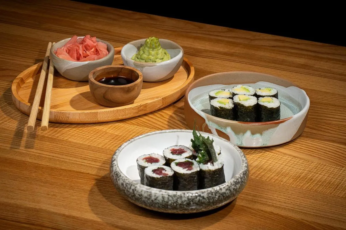 Maki rolls — tuna and cucumber wrapped in rice and nori — served in two small ceramic bowls