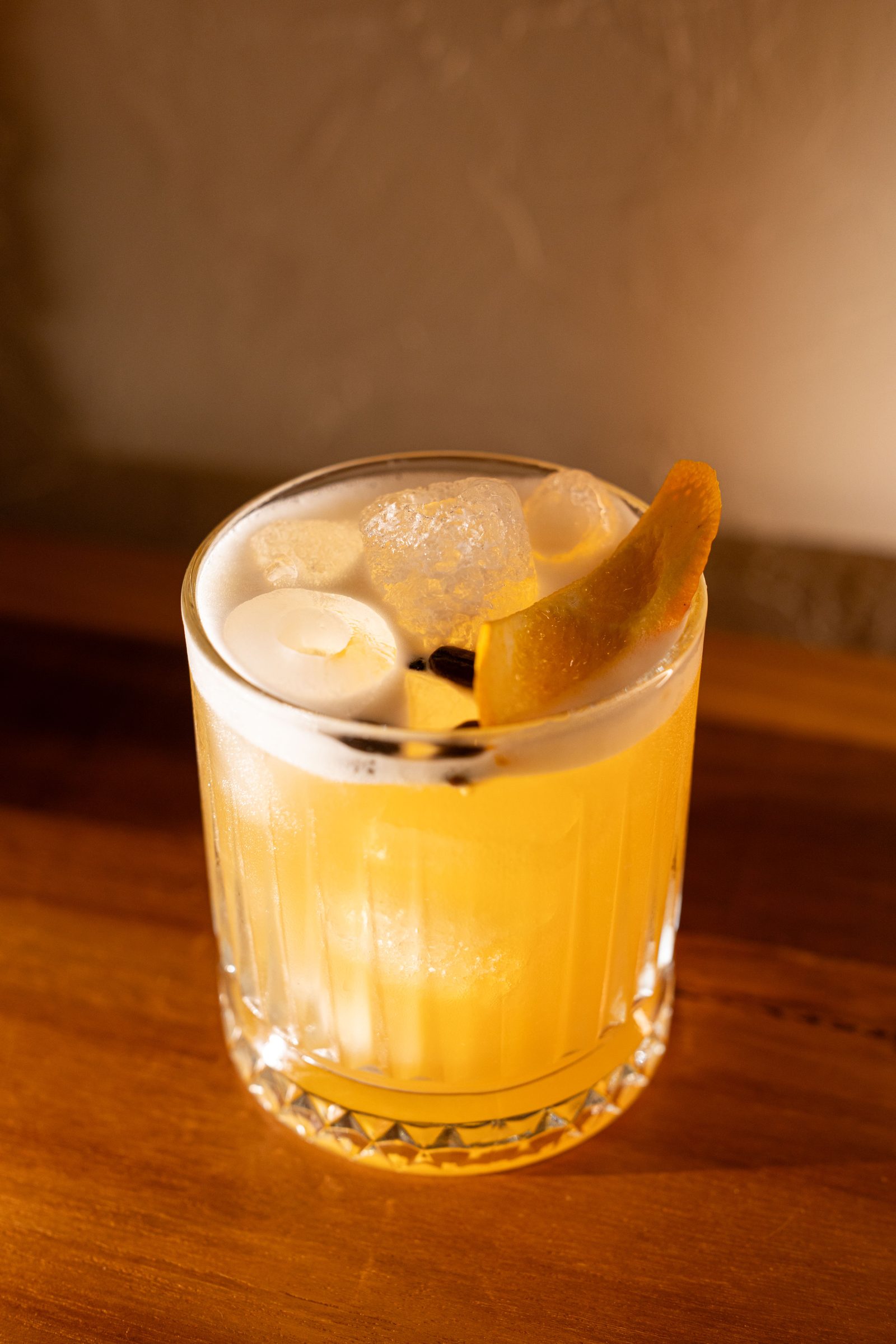 Signature amber cocktail with orange peel