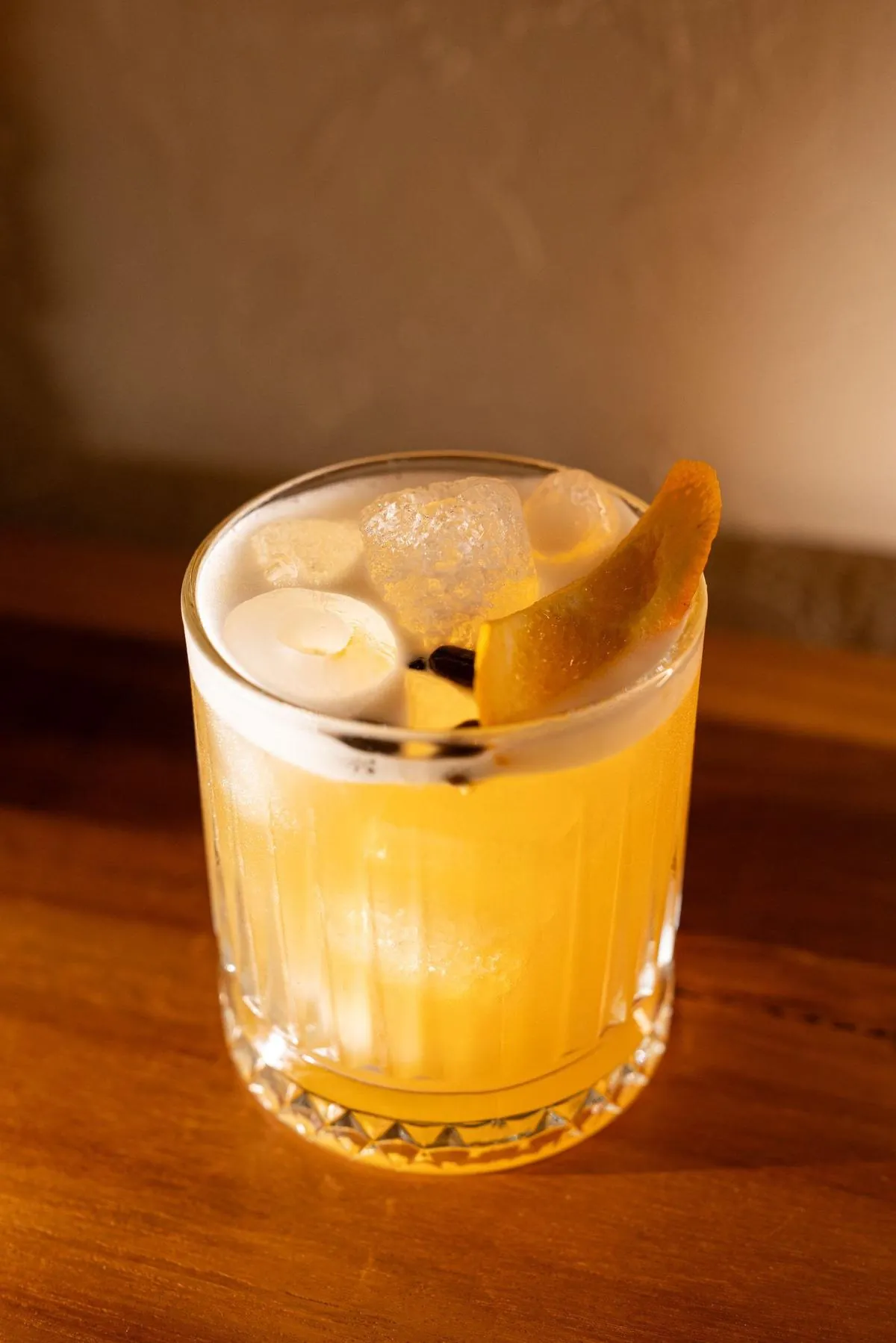 Signature amber cocktail with orange peel