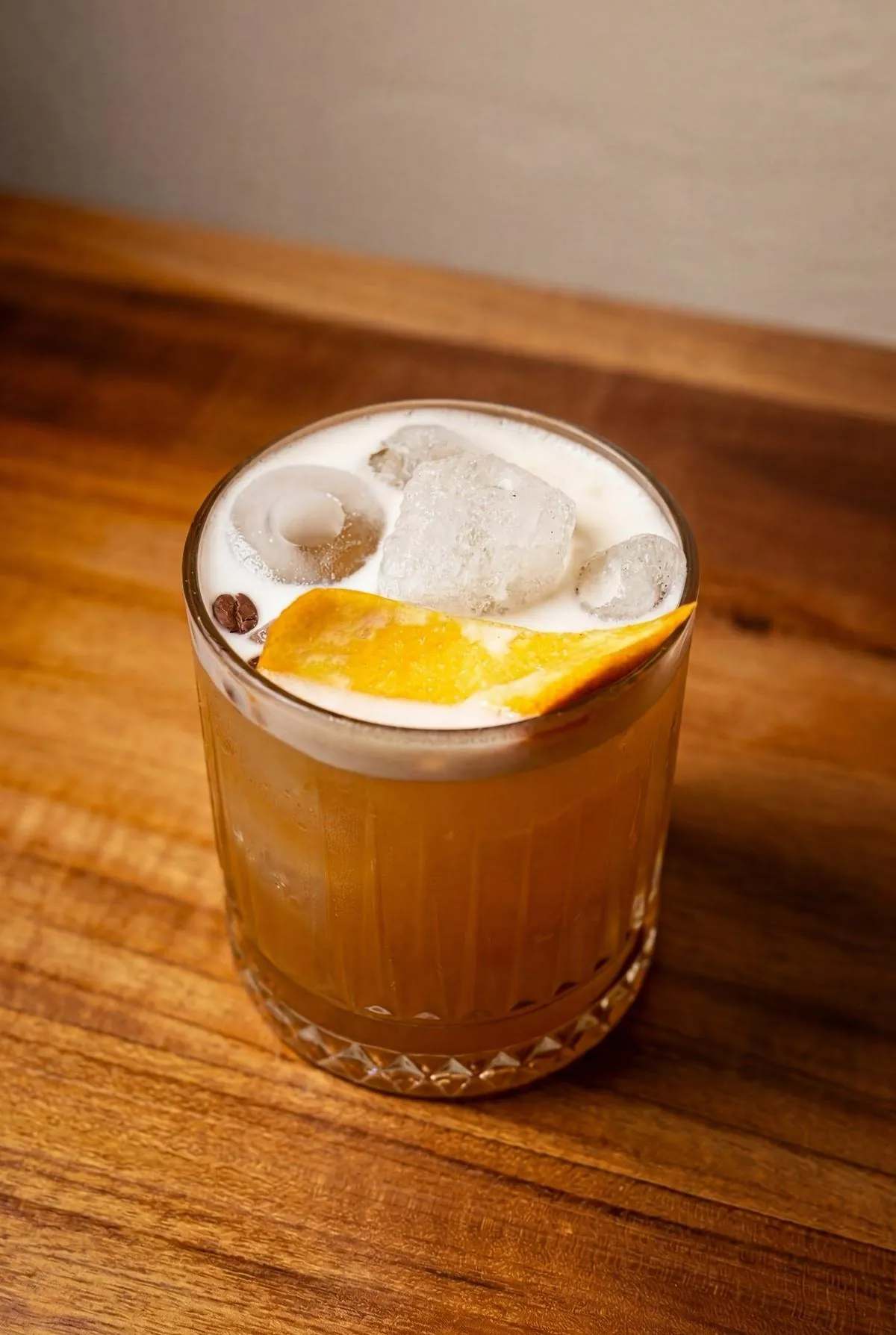 Signature amber cocktail on a wood table